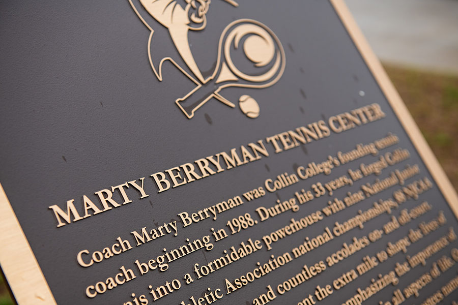 The plaque in front of the Marty Berryman Tennis Center bears the program-founding coach's name. 